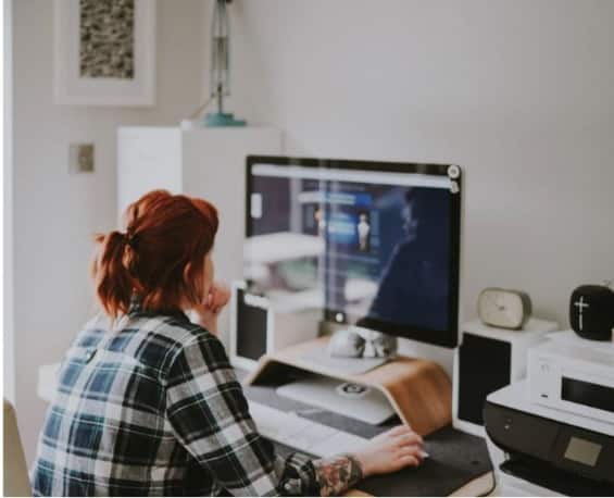 woman on her laptop working on becoming a travel agent 