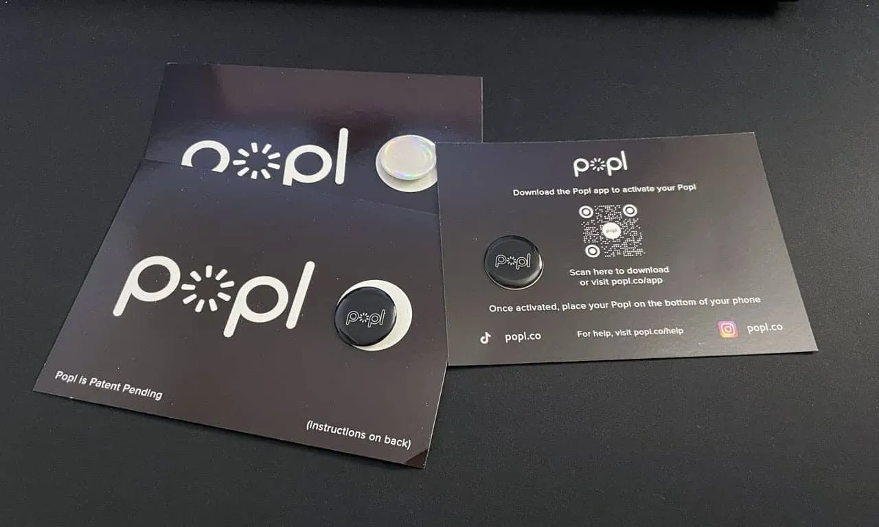 Popl NFC business card sticker attached to phone case with sleek black design and logo